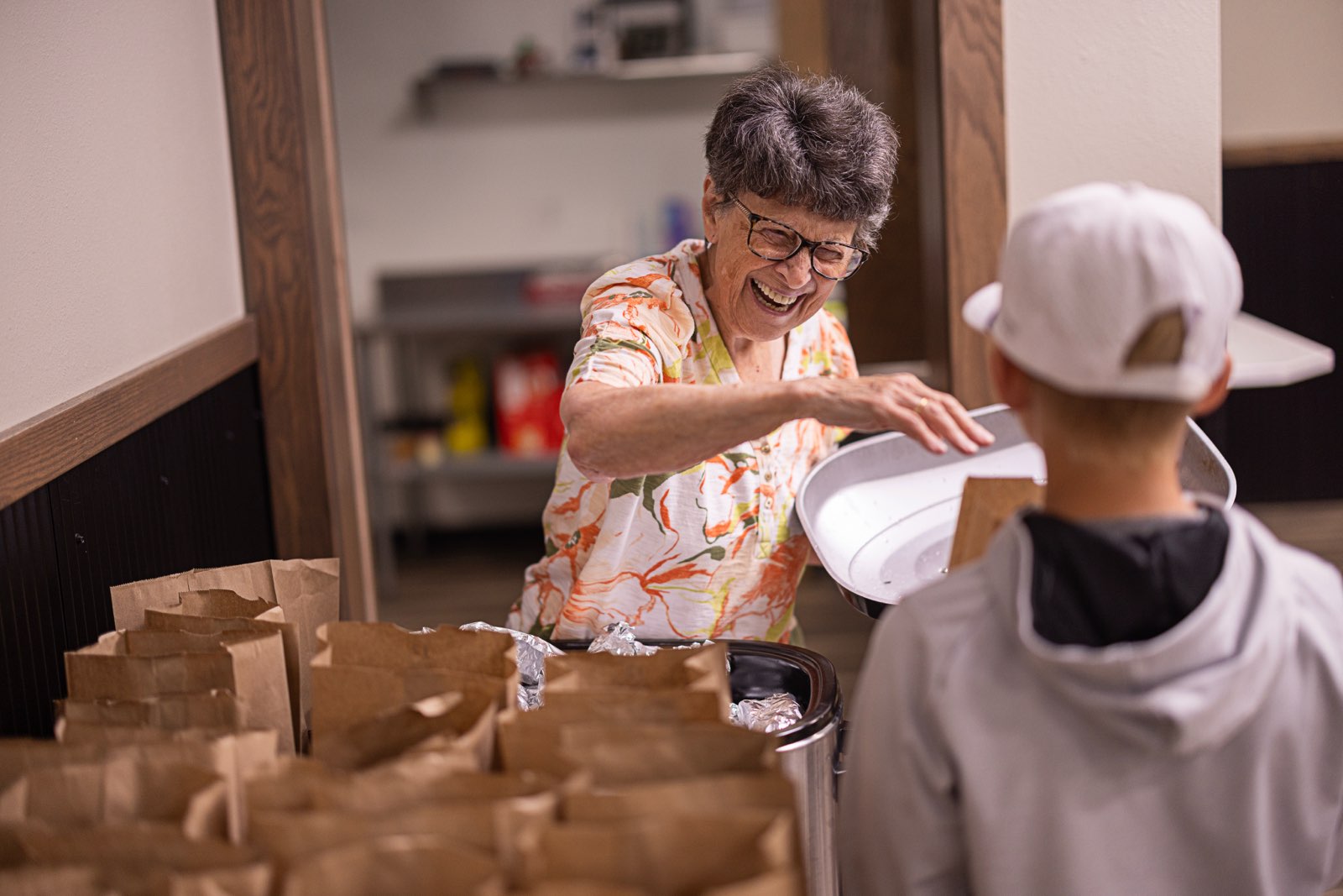 food pantry volunteer giving out summer lunch to kids