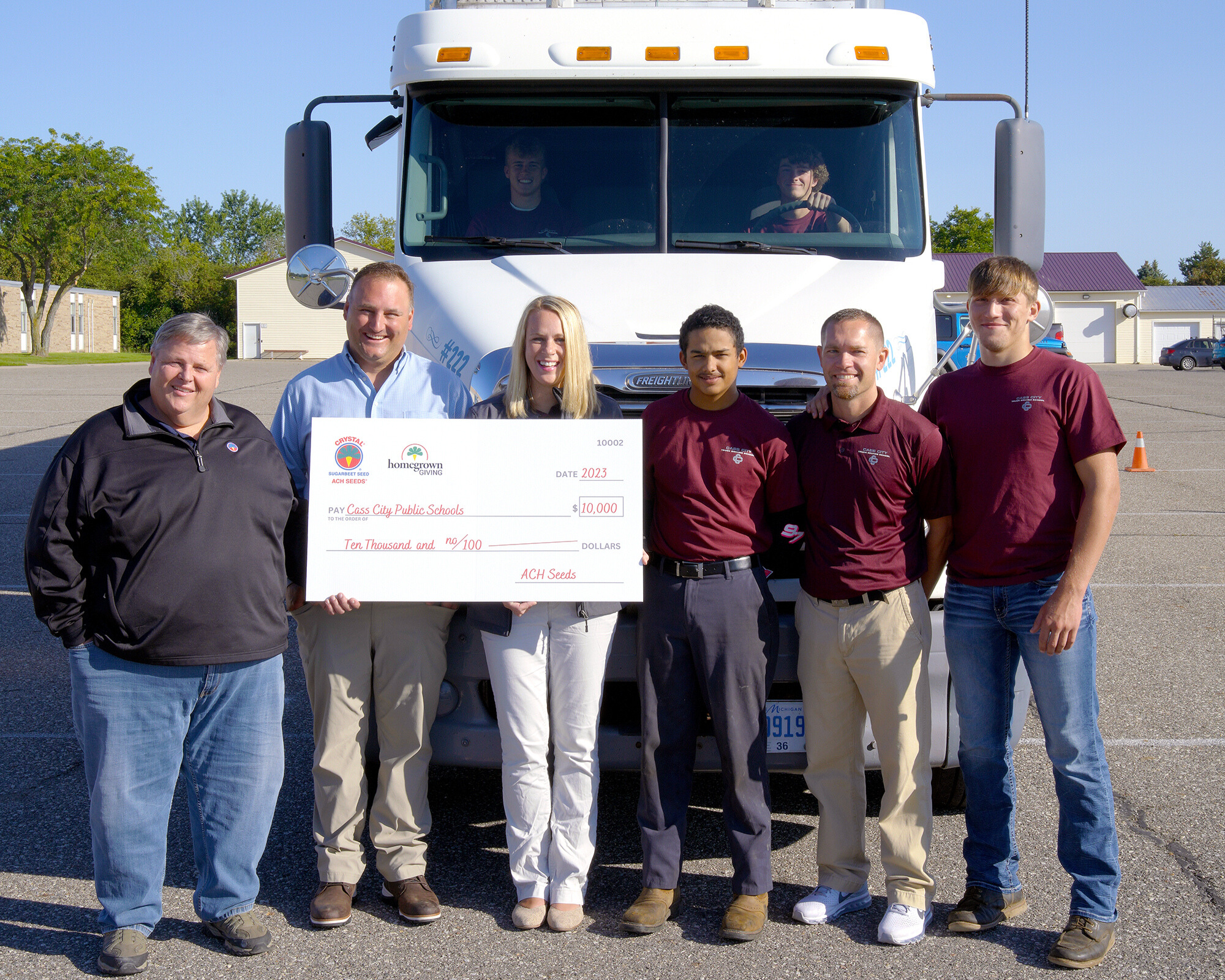 cass city public schools holding their $10,000 check